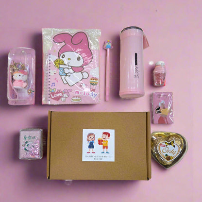 Collection of stationery items including a pink notebook, water bottle, and small figurines on a pink background.
